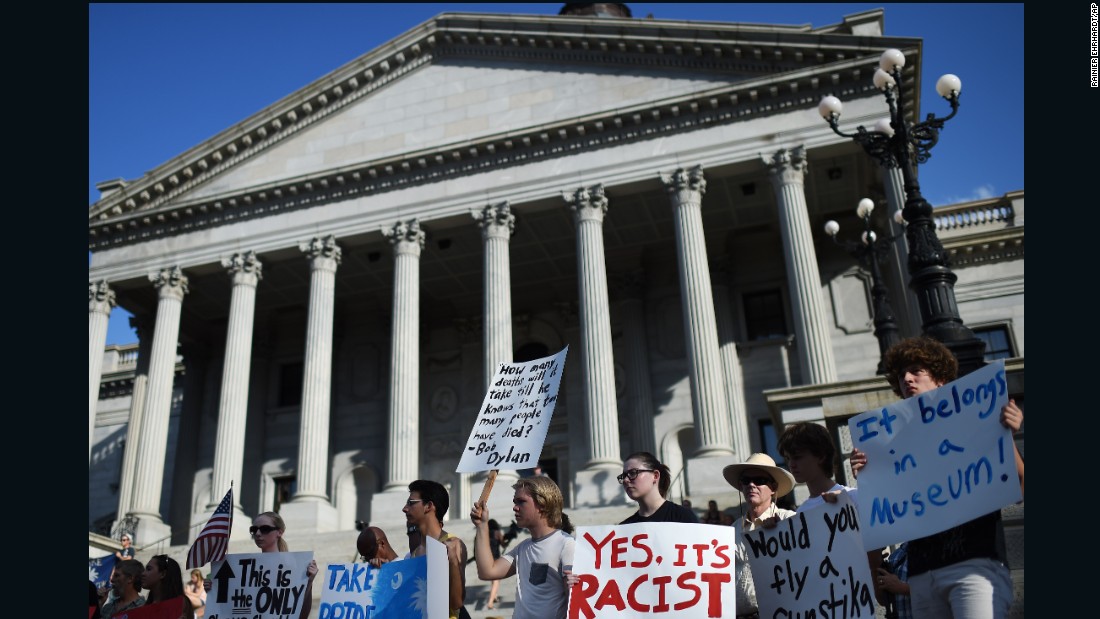 Protesters stand on the South Carolina State House steps during a rally to take down the Confederate flag, on Saturday, June 20, in Columbia. 