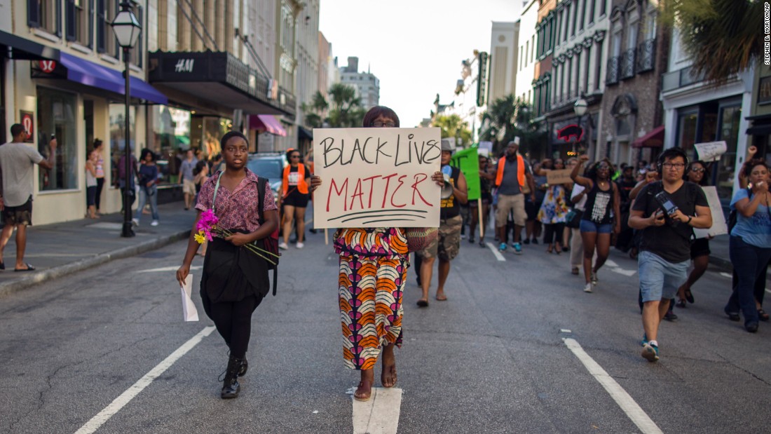 Louise Brown walks down King Street during a &quot;Black Lives Matter&quot; march on June 20 in Charleston, South Carolina. 