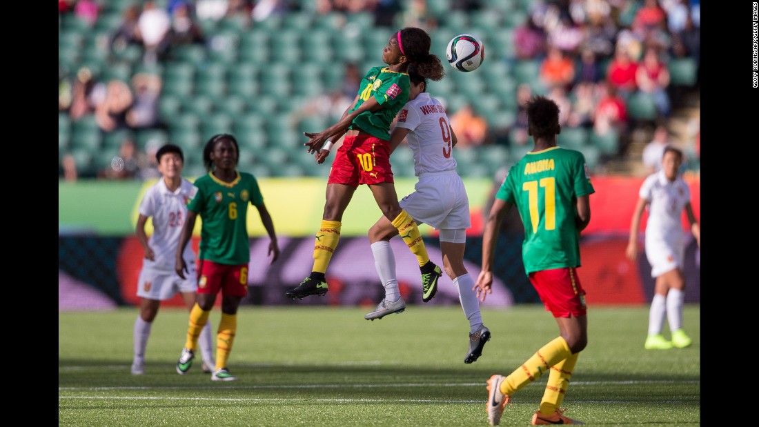 Cameroon&#39;s Jeannette Yango and China&#39;s Wang Shanshan compete for a header. 