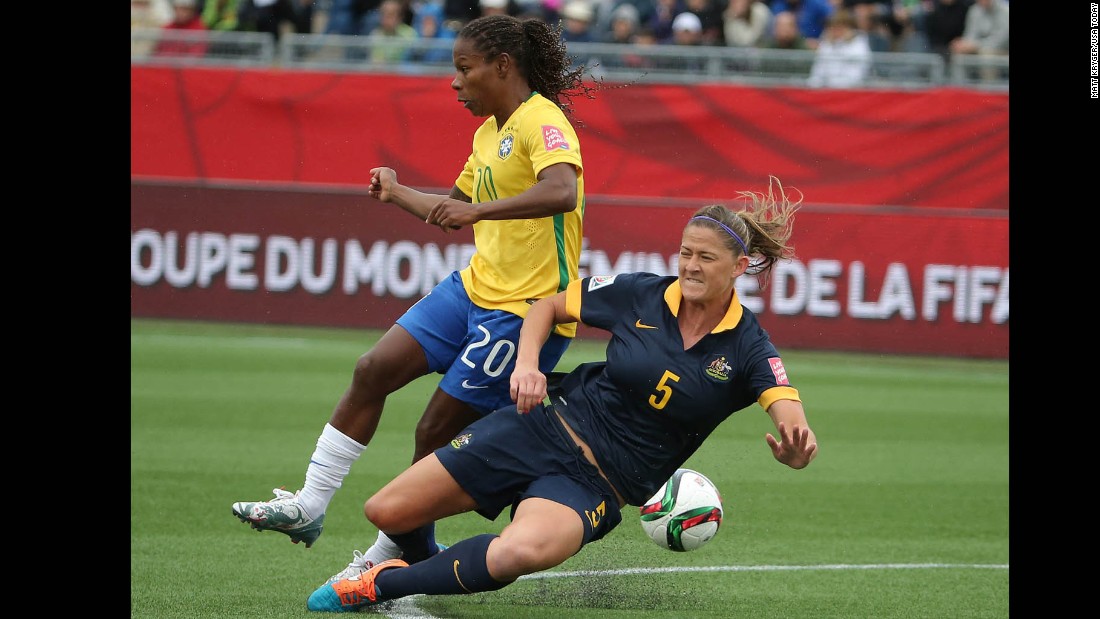 Australia&#39;s Laura Alleway, right, defends against Brazil midfielder Formiga during a match June 21 in Moncton, New Brunswick. Australia upset Brazil 1-0 to advance to the quarterfinals.