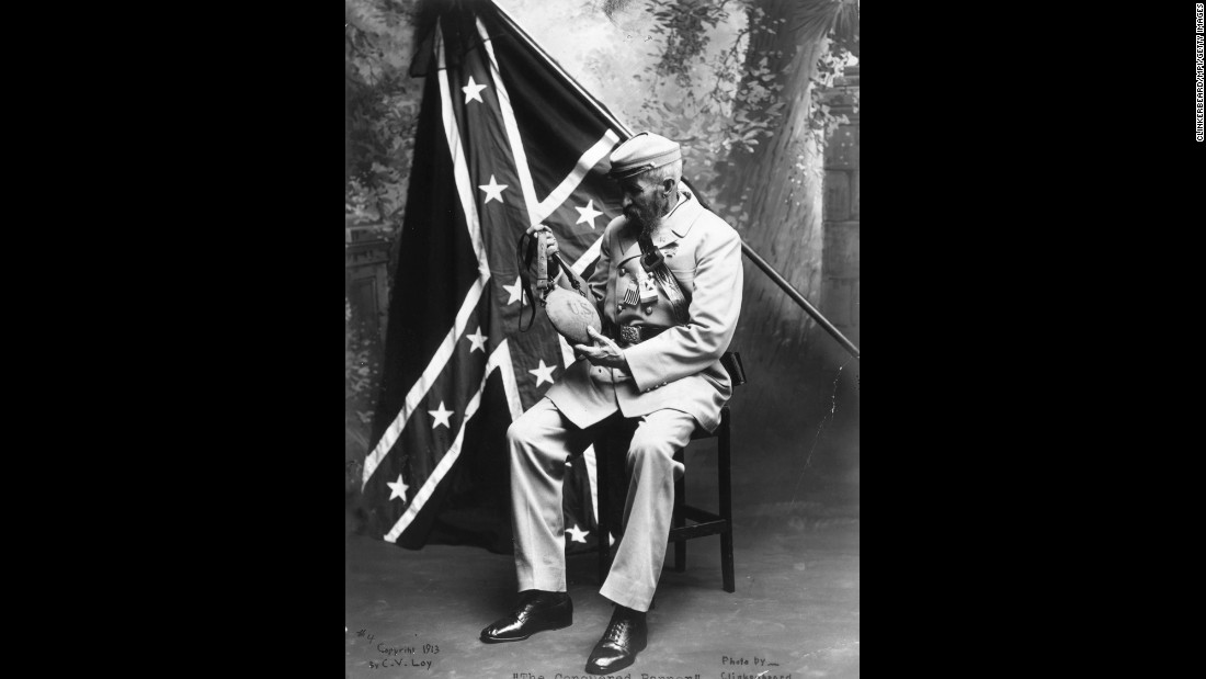 A veteran of the Confederate States of America examines a Union water bottle in front of a Confederate flag. Here&#39;s a look at the evolution of that flag.