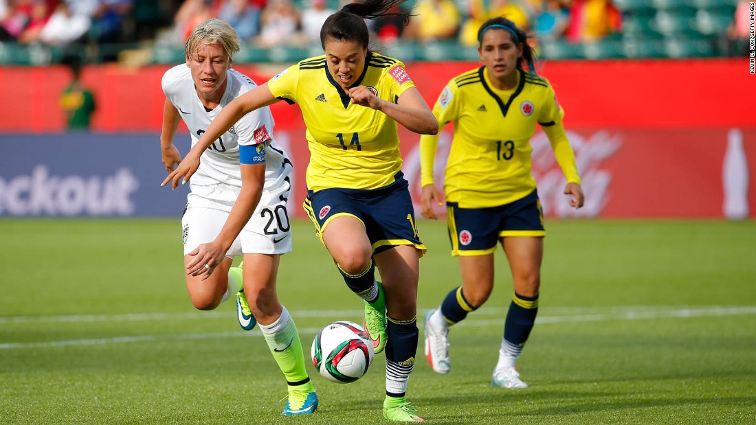 Nataly Arias of Colombia, center, controls the ball near U.S. forward Abby Wambach.