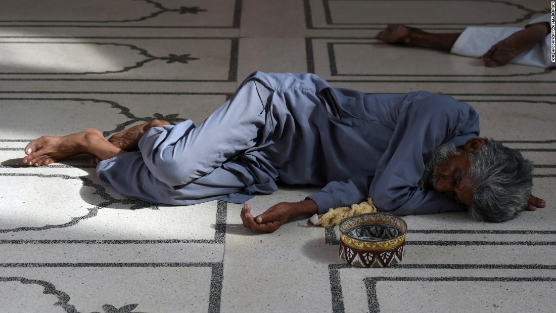 A Pakistani man rests at a mosque during the heat wave in Karachi on June 22.