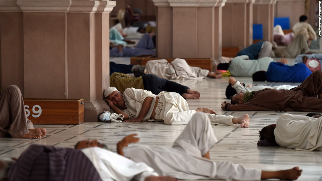 Pakistanis rest at the mosque during the heat wave in Karachi on June 22.