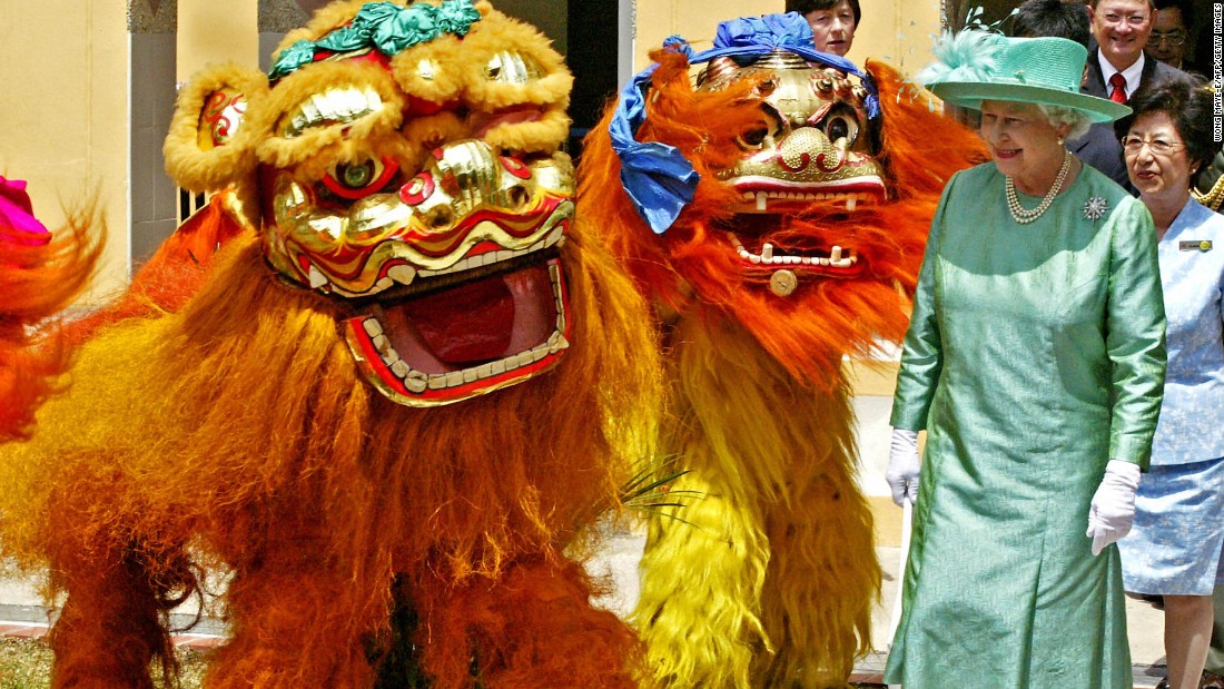 Visiting the former British colony of Singapore in March of 2006, Queen Elizabeth II watches a Chinese Lion Dance troop perform at the Toa Payoh Housing Development Board estate.  