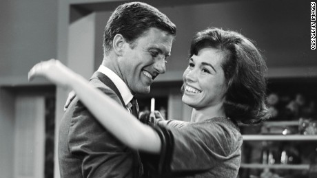 Dick Van Dyke as Rob Petrie and Mary Tyler Moore as Laura Petrie on the set.