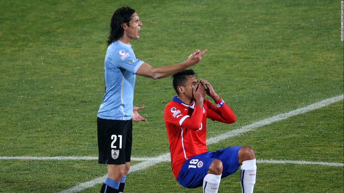 Gonzalo Jara falls to the floor after Edinson Cavani reacts to the Chilean&#39;s unwanted attention. The Uruguayan player was sent off after hitting the defender following his unusual action. Chile went on to win the 2015 Copa America quarterfinal 1-0. 