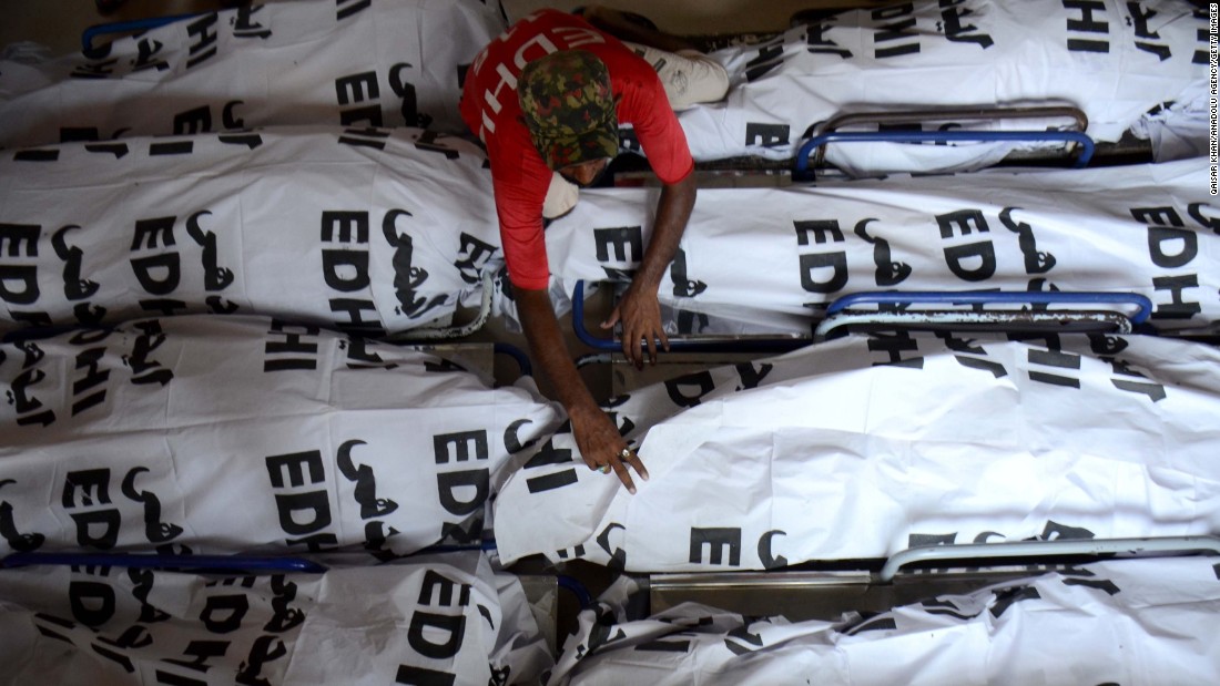 Covered corpses from a devastating heat wave lie in a mortuary in Karachi, Pakistan, on June 26. The death toll from the heat wave in Sindh province topped 1,000, officials told CNN.