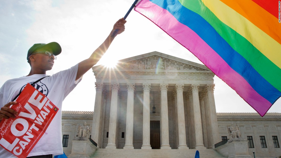 Carlos McKnight of Washington waves a rainbow flag in support of same-sex marriage on June 26. &lt;a href=&quot;http://www.cnn.com/2012/11/16/us/gallery/same-sex-marriage/index.html&quot;&gt;See photos from states that approved same-sex marriage before the Supreme Court ruling&lt;/a&gt;