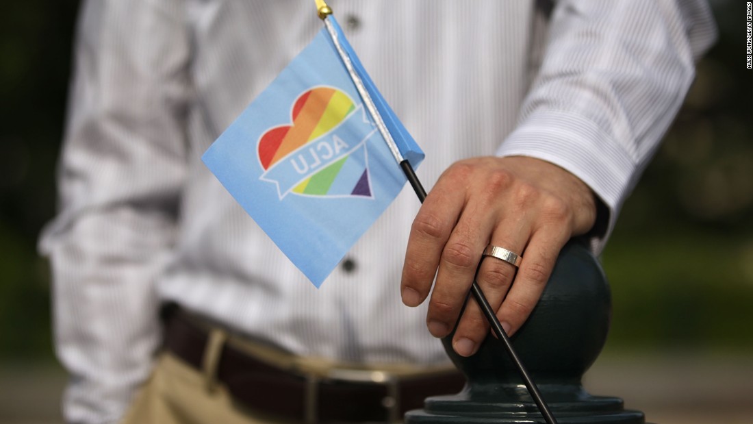A man holds a rainbow flag outside the Supreme Court on June 26.