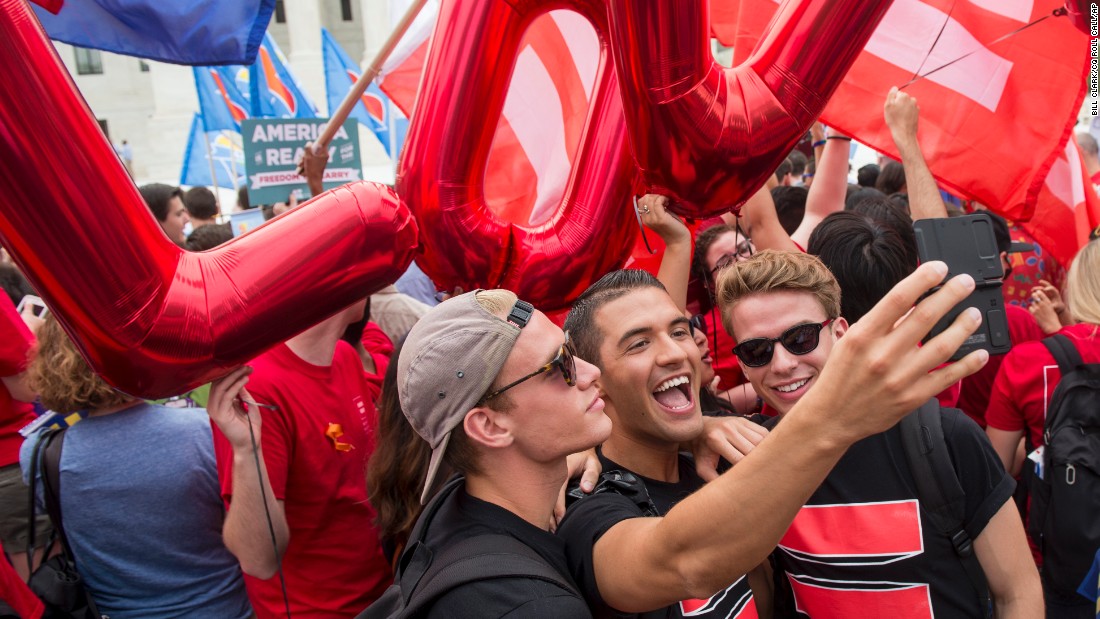 A group of same-sex marriage advocates film a video selfie in front of the Supreme Court on June 26.