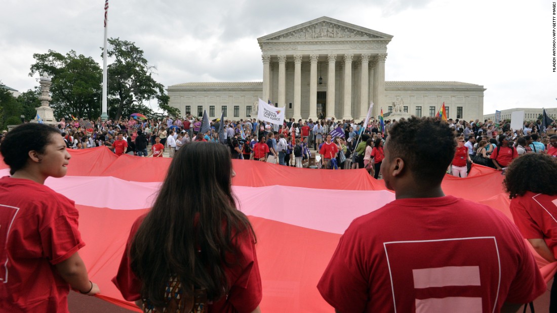 People wave a giant equality flag as they celebrate outside the Supreme Court on June 26.