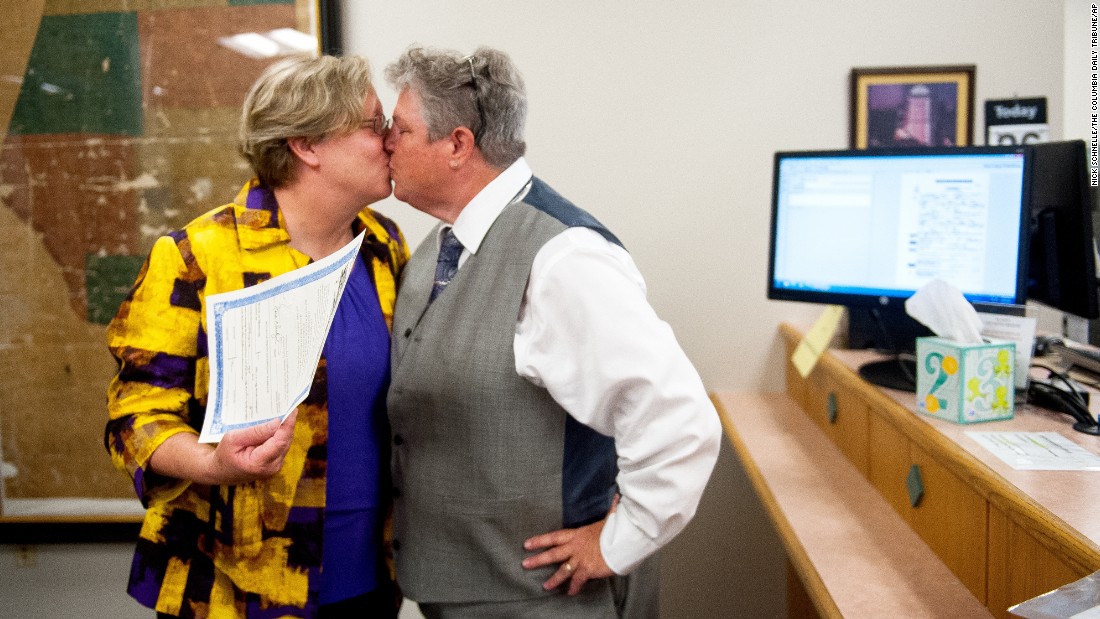 Laura Zinszer, left, and Angela Boyle kiss after receiving their marriage license June 26 in Columbia, Missouri. They were Boone County&#39;s first same-sex couple to receive their marriage license.