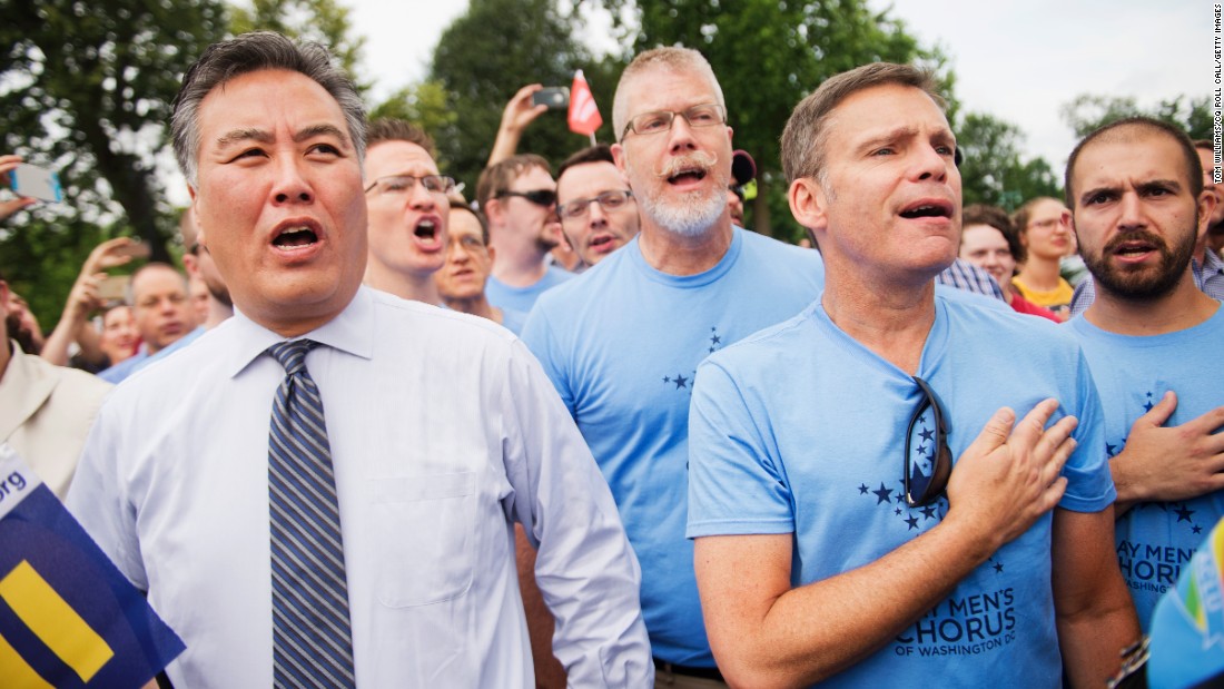 U.S. Rep. Mark Takano of California sings the national anthem June 26 with members of the Gay Men&#39;s Chorus of Washington.