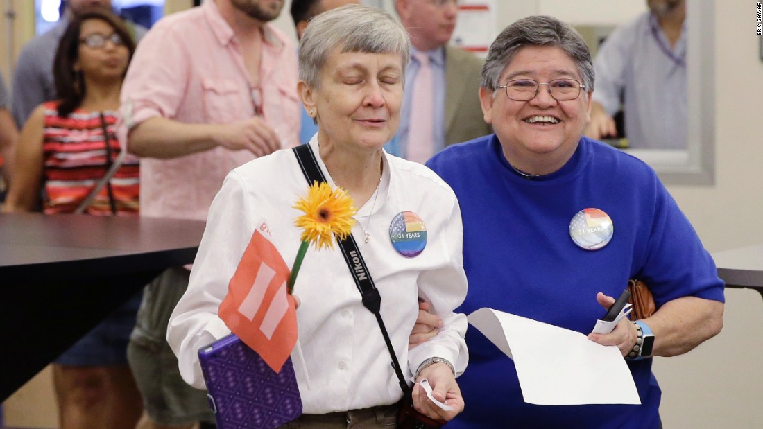 Jaque Roberts, left, and her partner of 31 years, Carmelita Cabello, arrive at the Travis County building in Austin, Texas, for a marriage license on June 26.