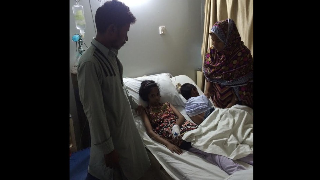 Sameer&#39;s wife Husna holds vigil by her children&#39;s bedside. They are depending on charity to continue keeping them in the hospital.