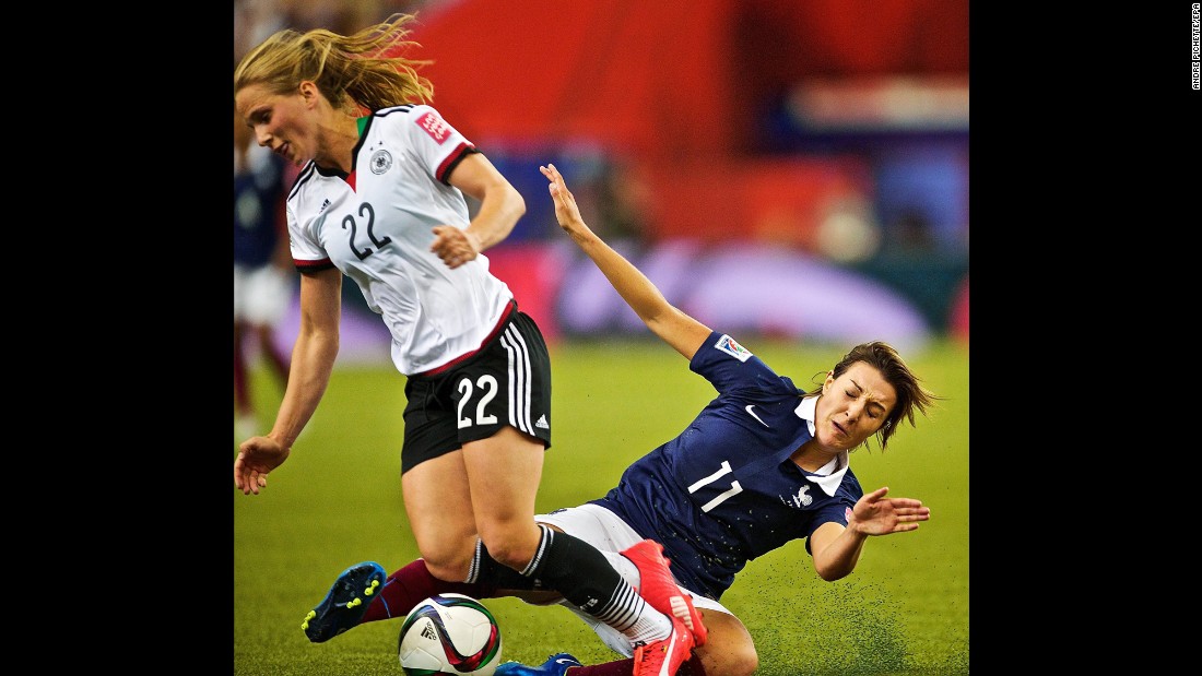 French midfielder Claire Lavogez slides in on  German midfielder Tabea Kemme.