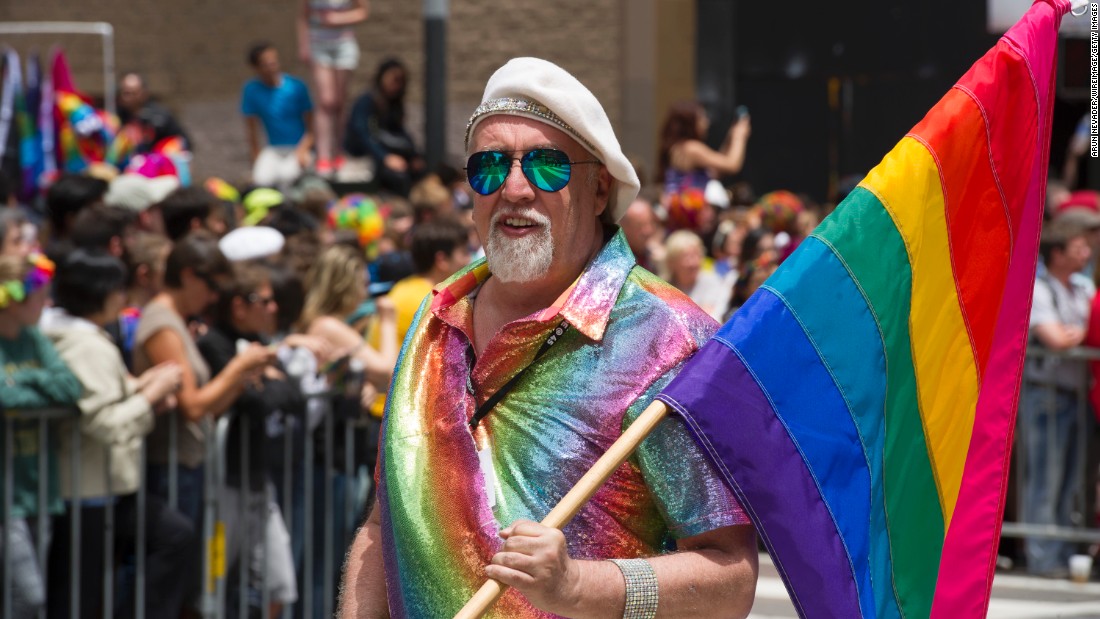 Rainbow flag creator Gilbert Baker marches during the 2015 San Francisco Pride Parade. Baker says he wept when the Supreme Court announced its decision making same-sex marriage legal nationwide.