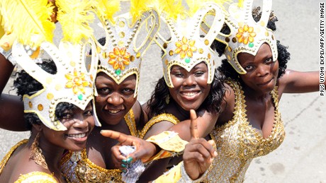 Young women pose during Lagos Carnival 2012. How much do their lives differ from their male counterparts?