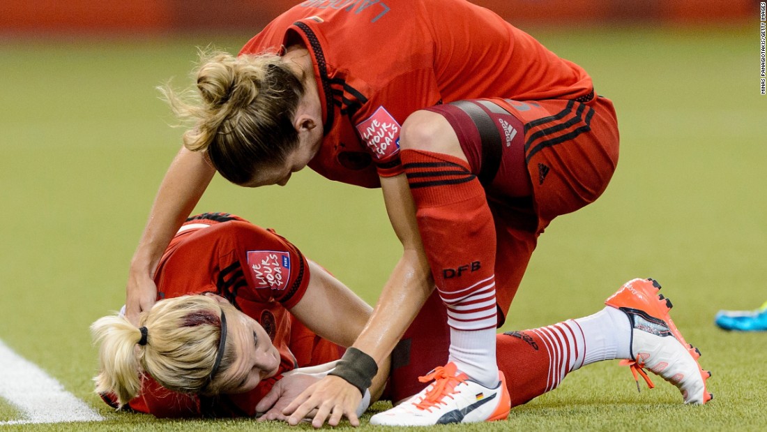 Germany&#39;s Alexandra Popp, left, clashed heads with American Morgan Brian early in the match. Both players received treatment and returned to action.