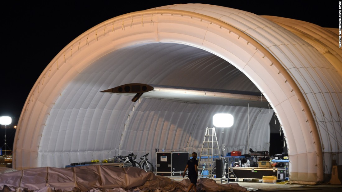 A mobile hangar is opened on Tuesday, June 23, as the plane is prepared for a possible takeoff.  The plane had been waiting in Japan for three weeks because of bad weather. 