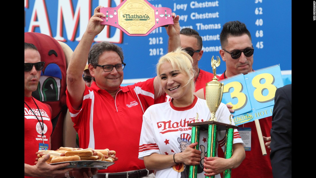 Miki Sudo holds her trophy after devouring four more hot dogs than she did last year and winning the annual Fourth of July competition.