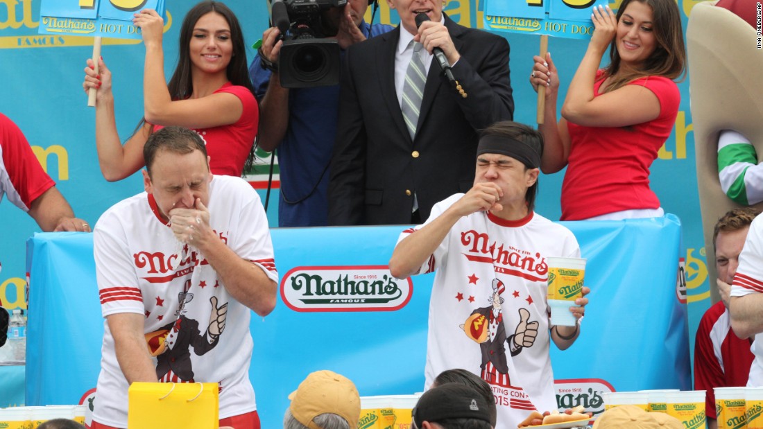 Joey Chestnut, left, and rival Matt Stonie struggle to down hot dogs and buns on the Fourth of July at Coney Island.
