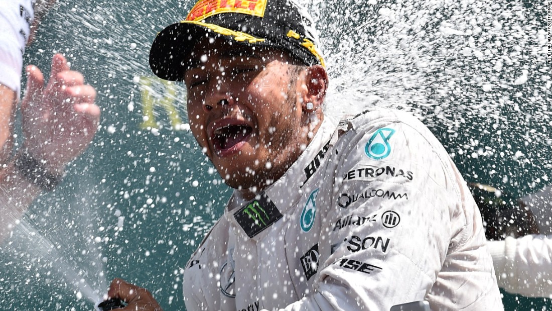Lewis Hamilton sprays the bubbly after his battling victory at the British Grand Prix to extend his title lead over teammate  Nico Rosberg.