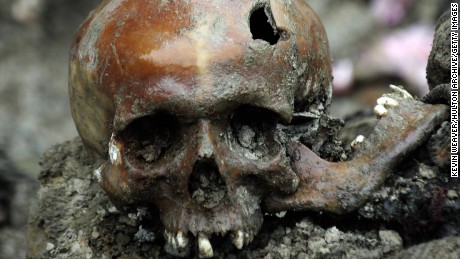 A broken skull lays exhumed in a newly discovered mass grave site in the village of Budak, just a few hundreds meters away from the Memorial Center of Potocari, near the eastern Bosnian town of Srebrenica, 11 July 2007.