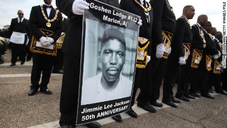 A marcher holds a poster of Jimmie Lee Jackson, a civil rights activist who was beaten and shot by Alabama State troopers in 1965, during the 50th anniversary commemoration of the Selma to Montgomery civil rights march on March 8, 2015 in Selma, Alabama. (Photo by Justin Sullivan/Getty Images)