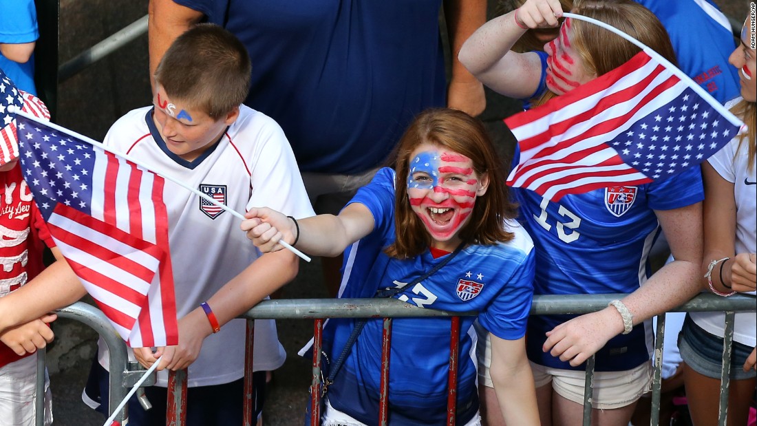 A young fan cheers while waiting for the ticker tape parade, the first in New York for a women&#39;s sports team.