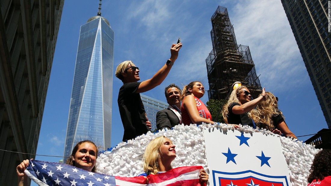U.S. forward Abby Wambach takes a photo aboard a float. The floats carried the players from Battery Park to City Hall. 