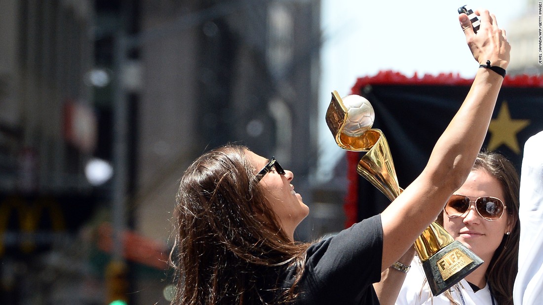 U.S. midfielder Carli Lloyd takes a selfie with the World Cup 2015 trophy during the ticker tape parade.