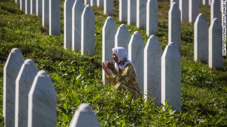 A woman prays at the Potocari cemetery and memorial near Srebrenica on July 10, 2015 in Srebrenica, Bosnia and Herzegovina. The newly-identified remains of another 136 victims from the Srebrenica massacre will be buried during a ceremony on July 11, 2015 on the 20th anniversary of the massacre. More than 8,000 Bosnian Muslim men and boys who had sought safe heaven at the U.N.-protected enclave at Srebrenica were killed by members of the Republic of Serbia army under the leadership of General Ratko Mladic, who is currently facing charges of war crimes at The Hague, during the Bosnian war in 1995.