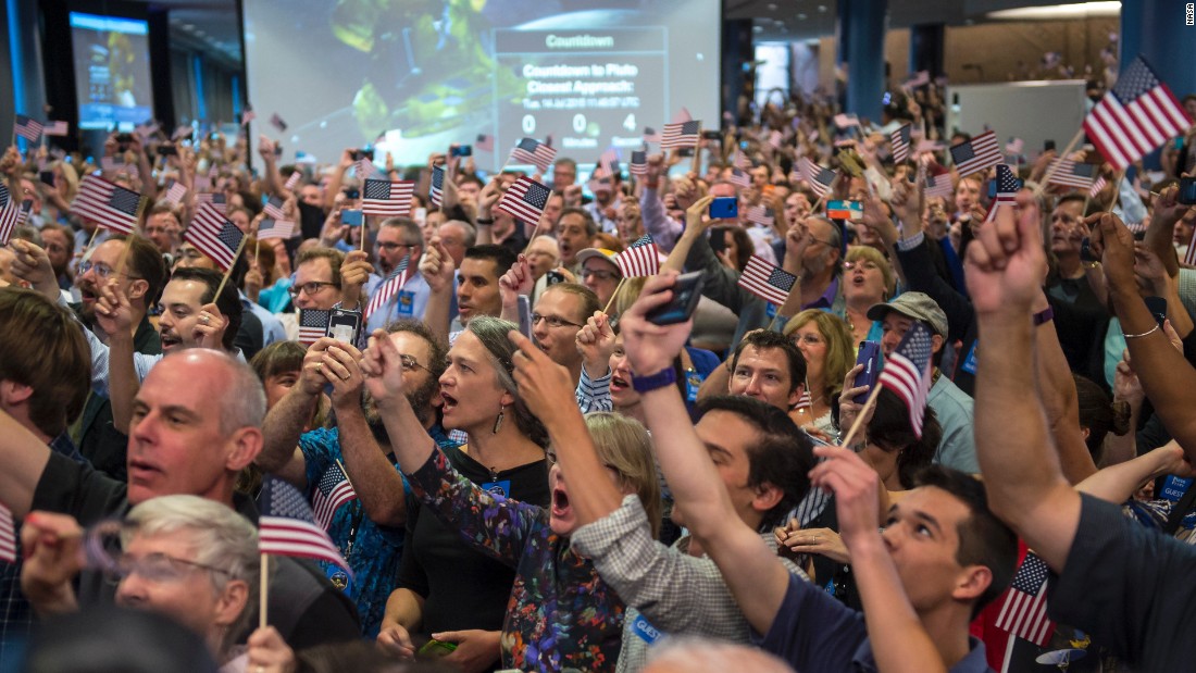 NASA team members and guests count down to the spacecraft&#39;s approach to Pluto on July 14.