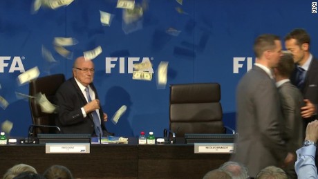 Comedian Lee Nelson throws money at Blatter during event