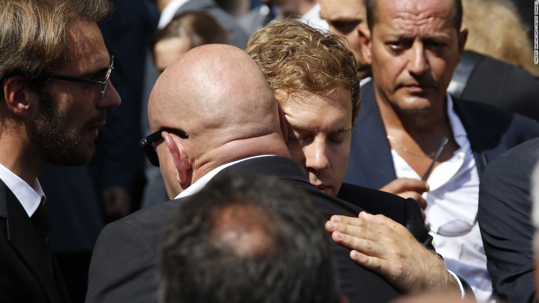 Sebastian Vettel (right) helped carry Bianchi&#39;s coffin. Here he hugs Philippe Bianchi, the father of Jules Bianchi.