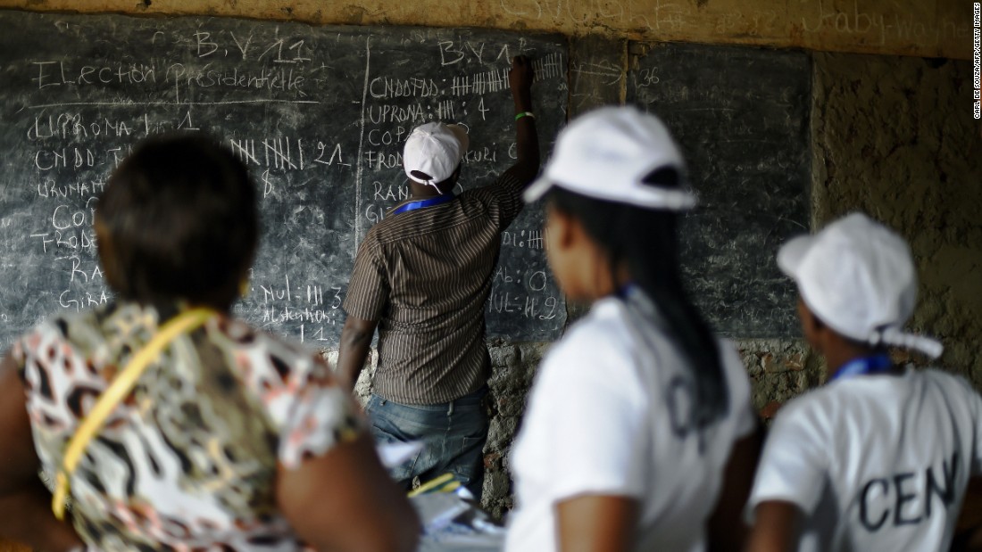 Election officials count votes at a polling station in Bujumbura on July 21.