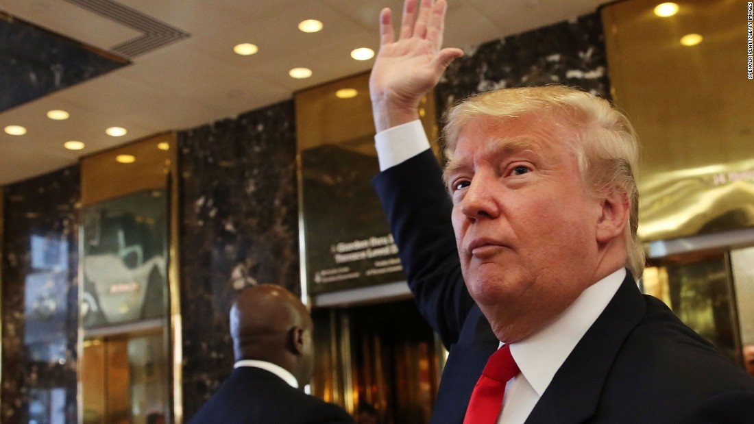 Trump greets onlookers after taping an interview with Anderson Cooper at a Trump-owned building in New York on July 22.