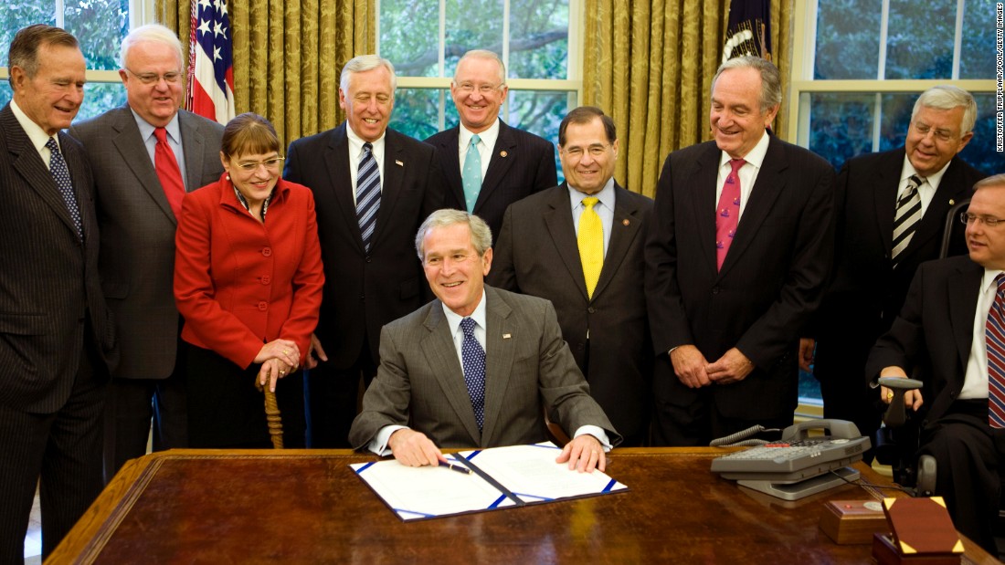 President George W. Bush signs the Americans with Disabilities Amendments Act of 2008. The law built on the ADA by broadening the definition of &quot;disability&quot; to include those with cancer, diabetes and epilepsy. His father, President George H.W. Bush, far left, signed the ADA in 1990.