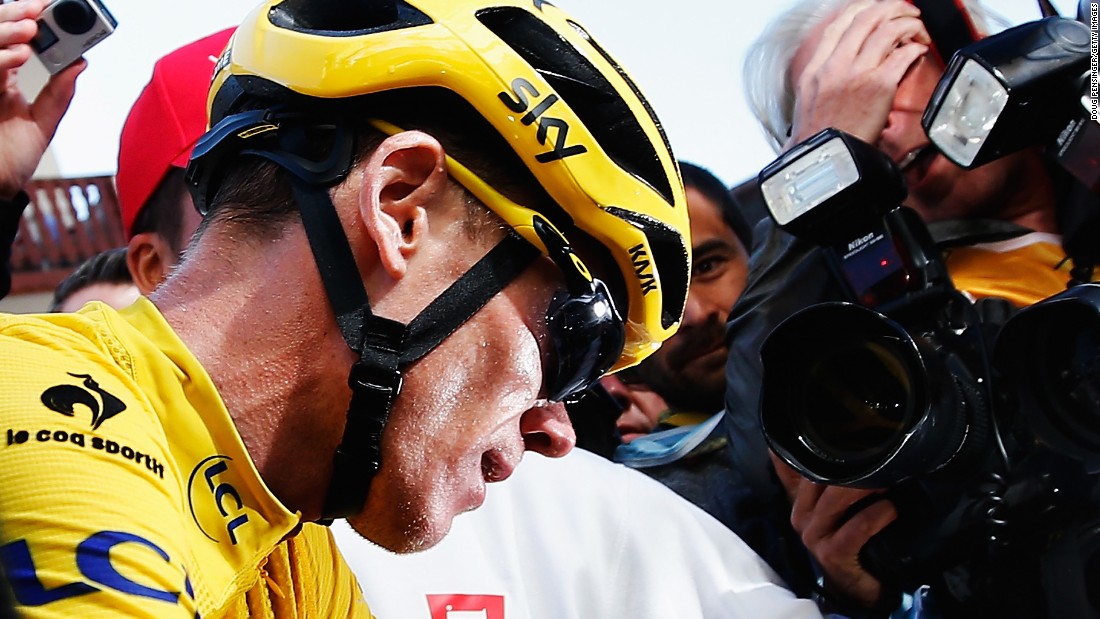 Froome is surrounded by the media after effectively sealing victory by protecting his advantage on the penultimate stage under strong challenge from Quintana.