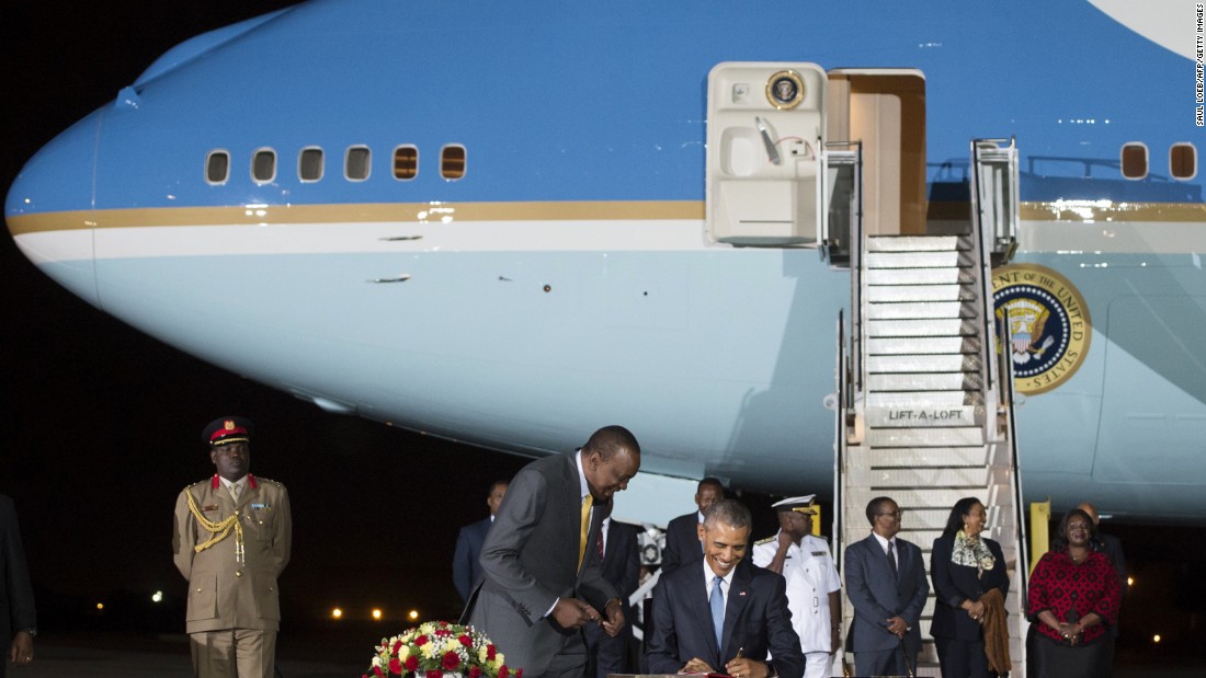 Obama signs a guest book alongside Kenyatta upon arrival at Kenyatta International Airport in Nairobi on Friday, July 24.