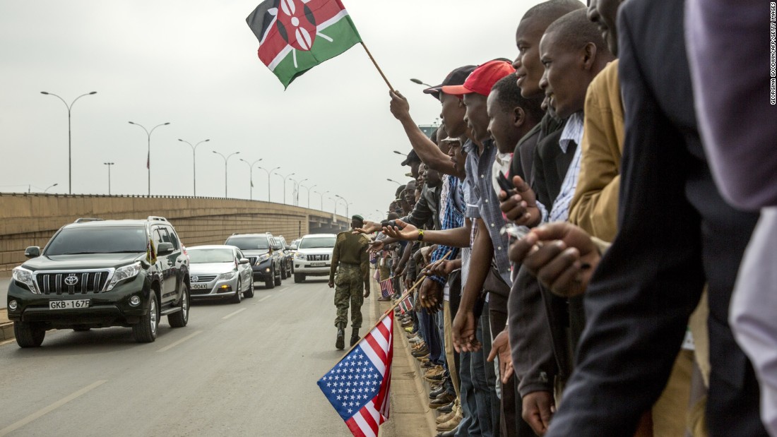 Kenyans wave to members of Kenya&#39;s Parliament as they wait for Obama&#39;s arrival on July 26.