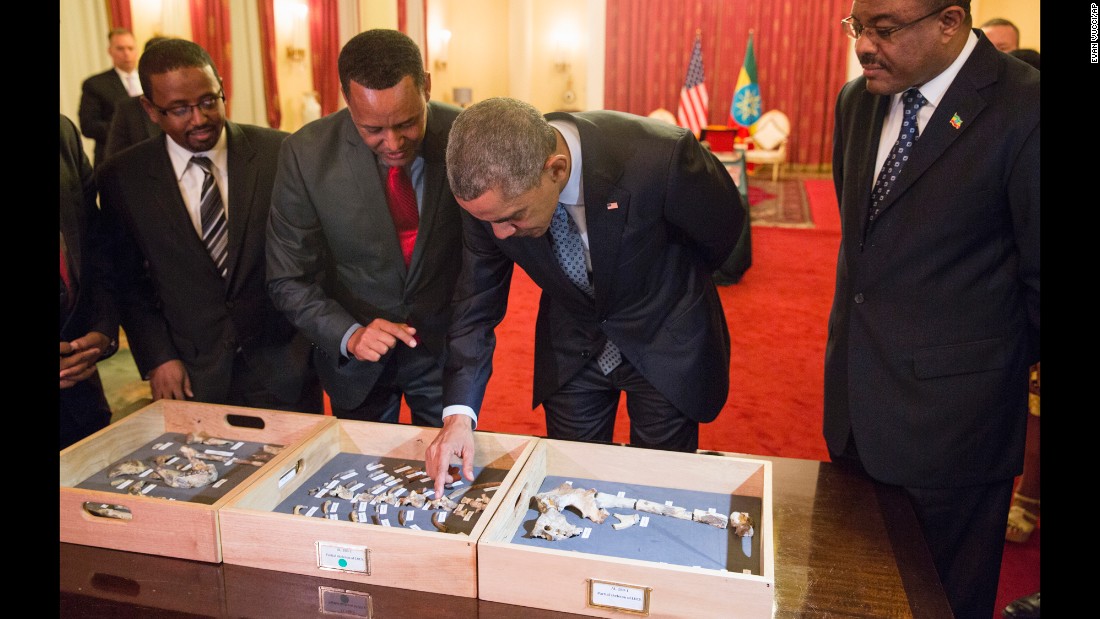 Desalegn, right, watches as Obama touches the &quot;Lucy&quot; exhibit at the National Palace on July 27. &quot;Lucy&quot; is made up of several hundred pieces of bone representing 40% of a female Australopithecus afarensis, a human-like species estimated to have lived in Ethiopia 3.2 million years ago.