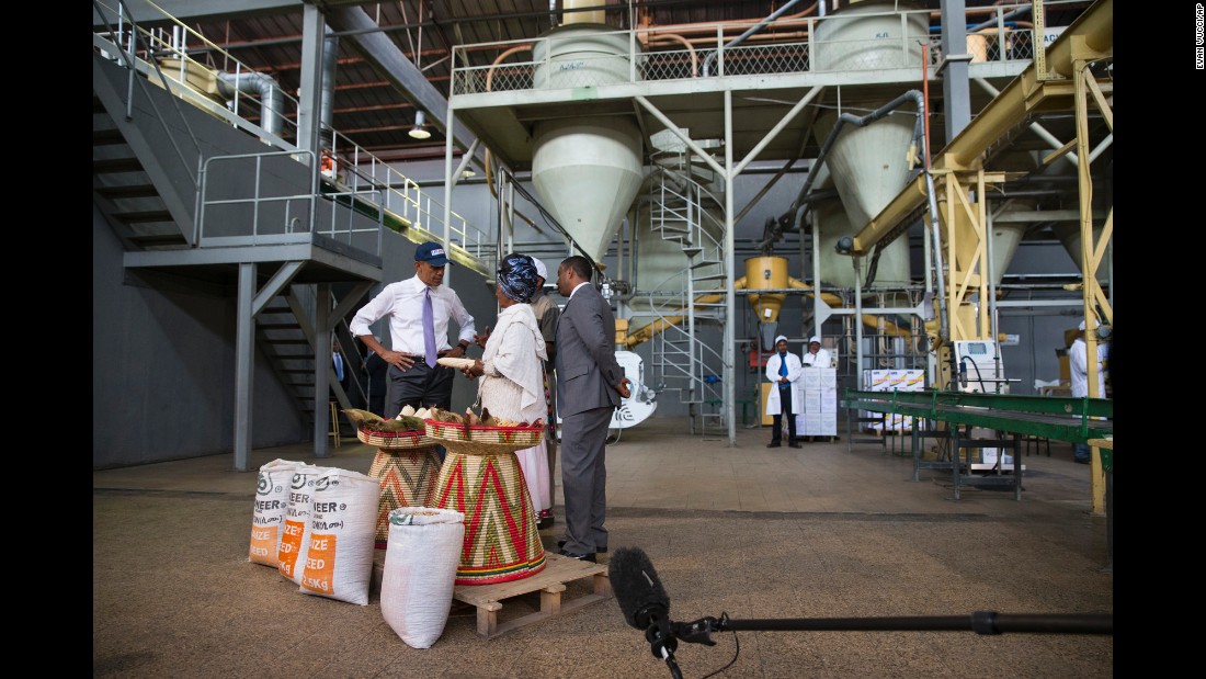 Obama talks with farmer Gifty Jemal Hussein, second from right, about her corn during a tour of Faffa Food in Addis Ababa on July 28.