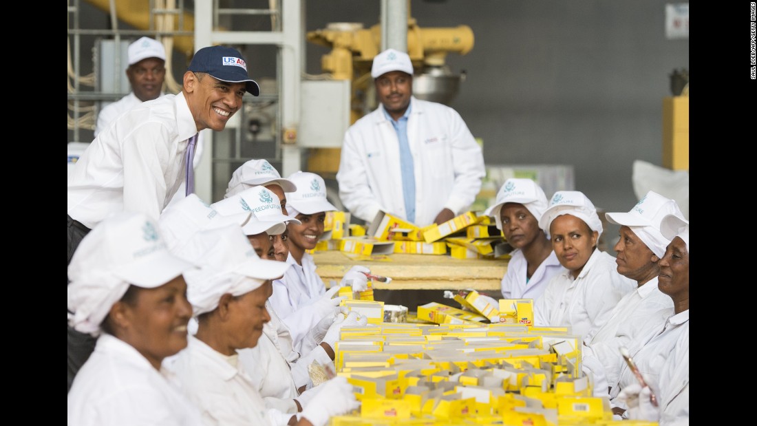 Obama stands alongside workers at Faffa Food as they pack boxes of food products in Addis Ababa on July 28. Faffa Food produces low-cost and high-protein foods.