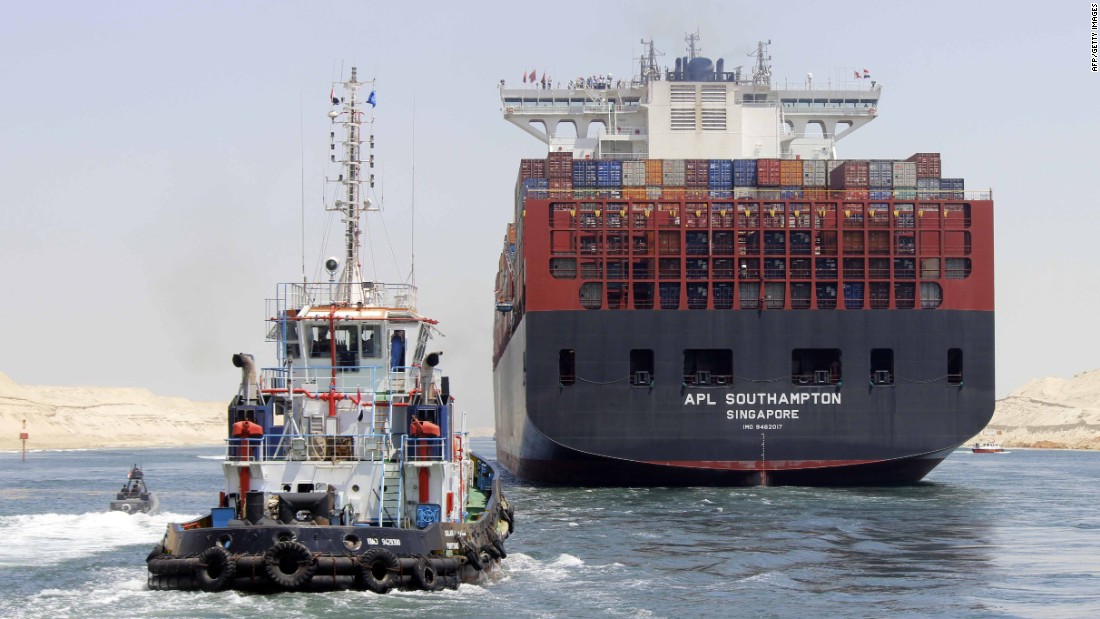 Boats, including a container ship, cross the new waterway of the Suez Canal on July 25, 2015, in the Egyptian port city of Ismailia, east of Cairo. Egypt started the first trial run of its &quot;new Suez canal,&quot; officials said, ahead of the new shipping route&#39;s formal inauguration on August 6, 2015 -- a year after construction began.
