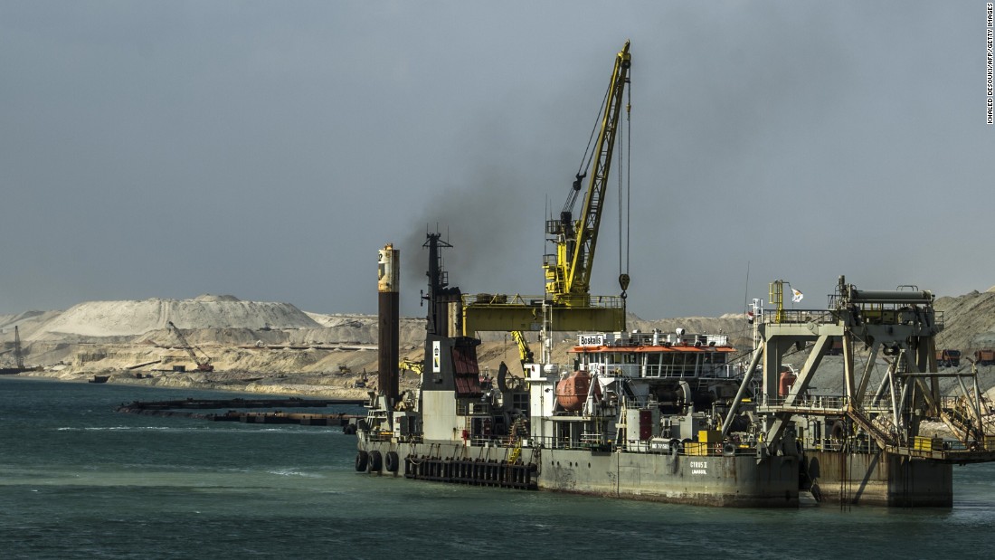 A dredger is seen at work on the new waterway of the Suez Canal on June 13, 2015, in the port city of Ismailia, east of Cairo. Dubbed the Suez Canal Axis, the new 72-kilometer project is aimed at speeding up traffic along the existing waterway and boosting revenues for Egypt. 41,000 people have been working since construction began last August, moving a total of half a trillion cubic meters of earth -- equivalent to moving 200 Great Pyramids.