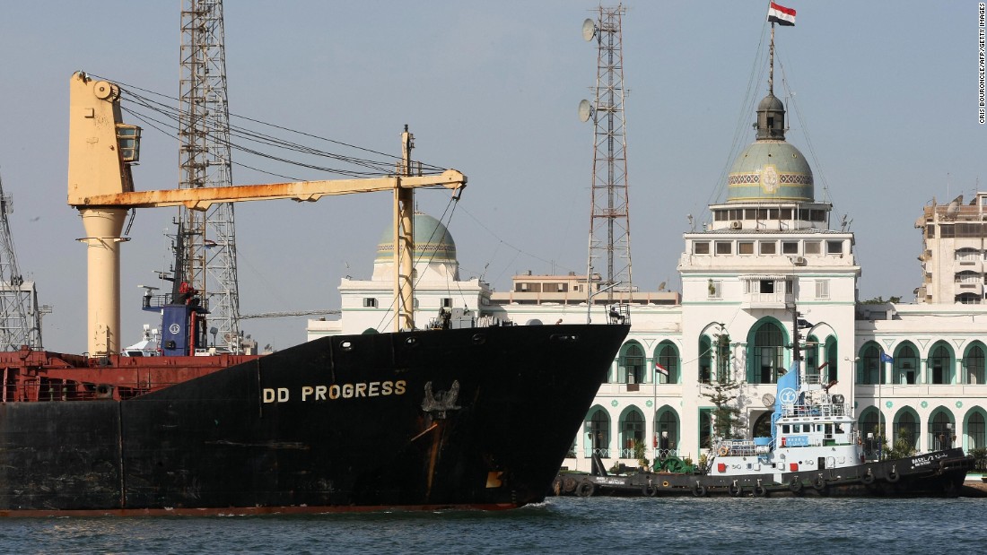 A cargo ship navigates past the Suez Canal Authority Building in Port Said, 180 kilometers northeast of Cairo, on November 24, 2008.