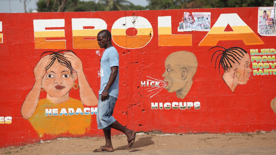 A man walks past an Ebola awareness painting in Monrovia on March 22, 2015.